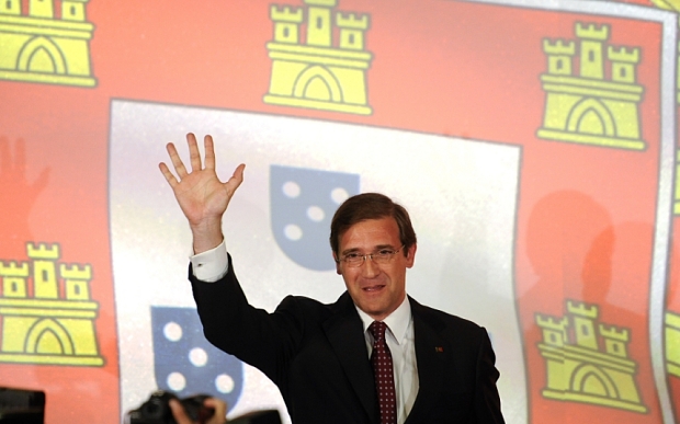 Pedro Passos Coelho, Portugal's prime minister and leader of the Social Democratic Party (PSD), waves to supporters after securing victory in the Portuguese election in Lisbon, Portugal, on Sunday, Oct. 4, 2015. While Coelho lost his majority in parliament, he decisively defeated Socialist leader Antonio Costa by focusing on the countrys economic progress, underscored by its exit from an international bailout in 2014. Photographer: Paulo Duarte/Bloomberg *** Local Caption *** Pedro Passos Coelho